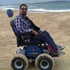 Wheelchair user on a beach using the Observer Beach Special Edition 4x4 Powered Wheelchair